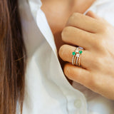 Braided rose gold ring with central emerald